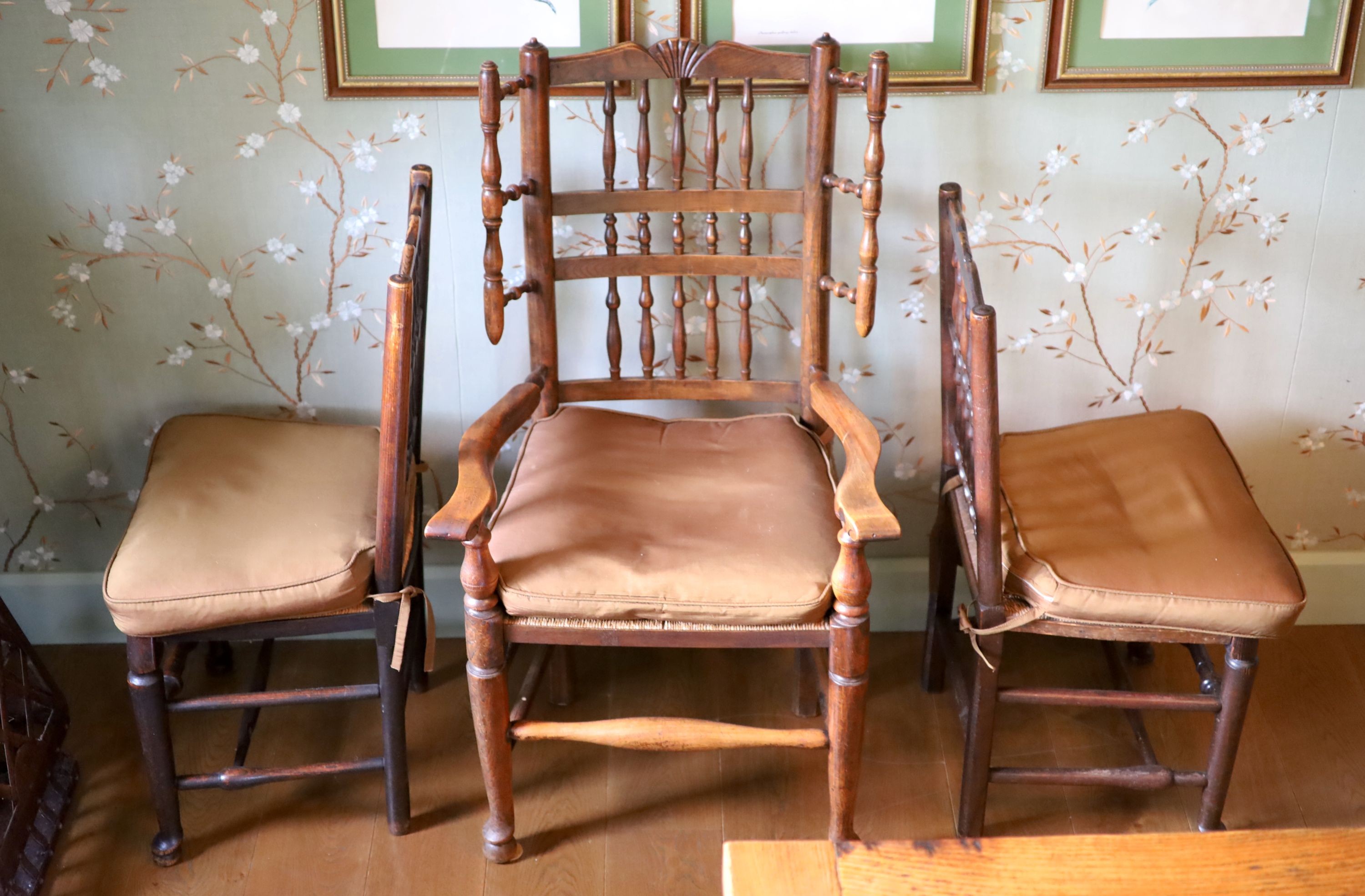 A harlequin set of twelve 19th century Derbyshire spindle back dining chairs, including two carvers, with rush seats and pad feet, height 93cm largest carver 115cm